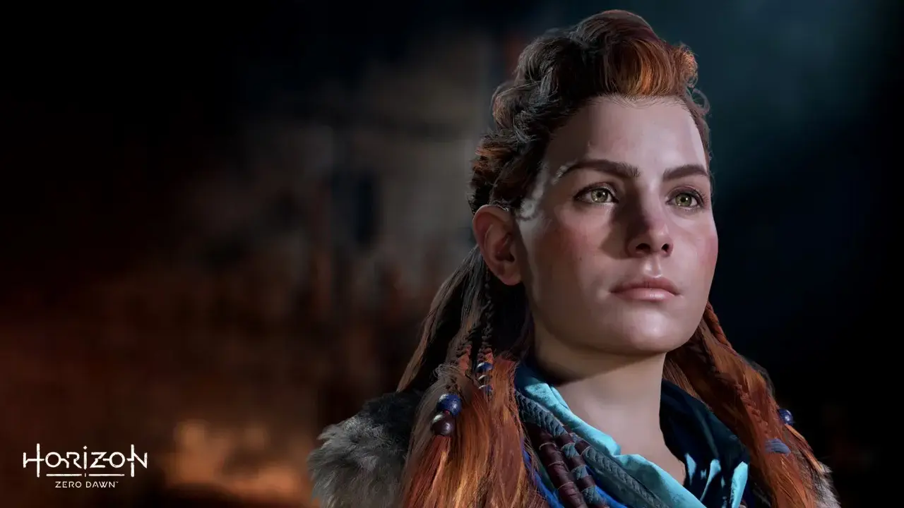 Aloy, protagonista de Horizon Zero Dawn 2, mira al horizonte con determinación. Su cabello pelirrojo trenzado y su mirada penetrante transmiten fuerza.
