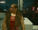 Un hombre con un abrigo de piel y un collar con plumas mira a un lado. En el fondo, luces de neón y la indicación "LA MALA REPUTACIÓN" sugieren un ambiente cyberpunk.
