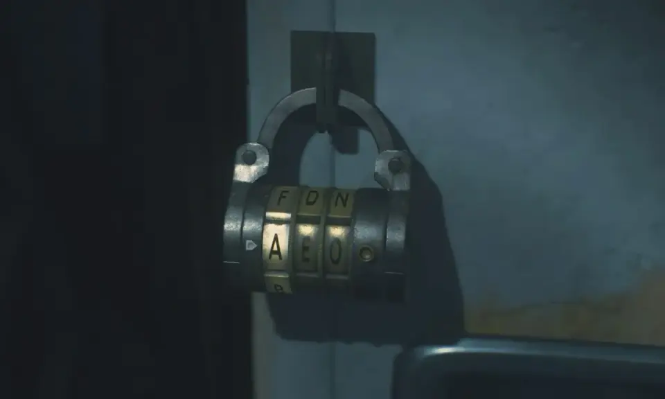 Caja fuerte de combinación en la oficina oeste de Resident Evil 2. Las letras visibles son F, D, N y A, E, O.