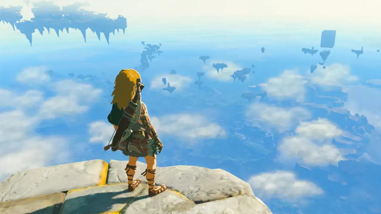 Link, protagonista de Zelda Tears of the Kingdom, contempla un vasto cielo azul con islas flotantes y ruinas.